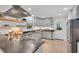 Modern kitchen features stainless steel appliances, grey cabinets, open shelving and light wood floors at 710 Spring Ln, Sanford, NC 27330