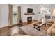 Cozy living room with a fireplace, mounted TV, and hardwood floors at 710 Spring Ln, Sanford, NC 27330