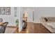 Warm living room showcases a stylish console table, hardwood floors and seamless flow to the dining space at 710 Spring Ln, Sanford, NC 27330