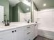 Bathroom with double vanity, modern light fixtures, and tub shower with white tile at 112 Bear Wallow Forest Way, Wendell, NC 27591