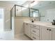 Modern bathroom with double vanity, black hardware, walk-in shower with glass enclosure and grey tile at 112 Bear Wallow Forest Way, Wendell, NC 27591