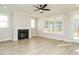 Cozy living room with wood flooring, a fireplace, and large windows offering lots of natural light at 112 Bear Wallow Forest Way, Wendell, NC 27591