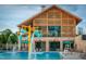 Community pool area with a splash pad, water features, and plenty of seating at 112 Bear Wallow Forest Way, Wendell, NC 27591