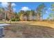 An expansive backyard featuring mature trees, ample space, and an idyllic country landscape at 1235 Schloss Rd, Louisburg, NC 27549