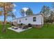 A cozy backyard patio features an outdoor seating area with plush cushions and scenic backyard views at 1235 Schloss Rd, Louisburg, NC 27549