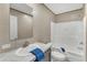 Bathroom featuring a single sink, a white tiled shower, and blue accents at 1235 Schloss Rd, Louisburg, NC 27549
