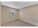 Empty bedroom featuring neutral walls, plush carpet, and a window with natural light at 1235 Schloss Rd, Louisburg, NC 27549