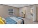 Bright bedroom featuring plush carpet, a window, and stylish staging with blue and yellow bedding at 1235 Schloss Rd, Louisburg, NC 27549