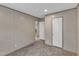 Empty bedroom featuring neutral walls, plush carpet, and two doors for access at 1235 Schloss Rd, Louisburg, NC 27549