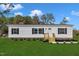 Charming new construction home featuring a landscaped yard and a welcoming entrance on a spacious 1+ acre lot at 1235 Schloss Rd, Louisburg, NC 27549