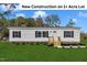 Charming new construction home featuring a landscaped yard and a welcoming entrance on a spacious 1+ acre lot at 1235 Schloss Rd, Louisburg, NC 27549