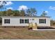 A charming single-story home with black shutters and a newly installed front porch and landscaping at 1235 Schloss Rd, Louisburg, NC 27549