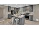 Modern kitchen boasts stainless steel appliances, gray cabinets, a kitchen island, and stylish decor at 1235 Schloss Rd, Louisburg, NC 27549
