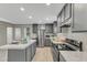 Well-lit kitchen with stainless steel appliances, gray cabinets, sleek countertops, and ample storage at 1235 Schloss Rd, Louisburg, NC 27549