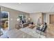 Bright living room with neutral decor, comfortable seating, a textured rug, and natural light from large windows at 1235 Schloss Rd, Louisburg, NC 27549