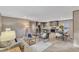 Open-concept living space with a kitchen, dining area, and comfortable seating with natural light and modern decor at 1235 Schloss Rd, Louisburg, NC 27549