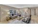 Bright and airy living area with large windows, comfortable seating, and stylish decor with access to other rooms at 1235 Schloss Rd, Louisburg, NC 27549