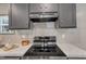 Close-up of a modern range stove with stainless steel accents and a granite countertop at 1235 Schloss Rd, Louisburg, NC 27549