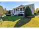 Well-manicured backyard featuring a covered porch area and mature landscaping at 1509 Heritage Reserve Ct, Wake Forest, NC 27587