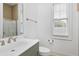 Bathroom features a vanity with sink, window with blinds and tiled shower at 1509 Heritage Reserve Ct, Wake Forest, NC 27587