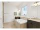 Luxurious bathroom featuring soaking tub, tiled floors, and dual vanities at 1509 Heritage Reserve Ct, Wake Forest, NC 27587