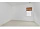 This bedroom has neutral carpeting and a window that provides natural light at 1509 Heritage Reserve Ct, Wake Forest, NC 27587