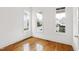 Sunlit bedroom features polished hardwood floors and white trim at 1509 Heritage Reserve Ct, Wake Forest, NC 27587