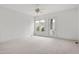 Spacious bedroom featuring neutral carpet, ceiling fan, and private balcony access at 1509 Heritage Reserve Ct, Wake Forest, NC 27587