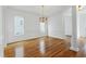 Bright dining room featuring wainscoting, wood floors, and an elegant chandelier at 1509 Heritage Reserve Ct, Wake Forest, NC 27587
