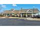 Image features the exterior of a community building with ample parking and manicured landscaping at 1509 Heritage Reserve Ct, Wake Forest, NC 27587