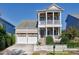 Charming home boasts a two-story porch, three-car garage, and a white picket fence at 1509 Heritage Reserve Ct, Wake Forest, NC 27587