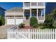 Two-story home with a two car garage and front yard with a white picket fence at 1509 Heritage Reserve Ct, Wake Forest, NC 27587