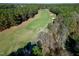 Aerial view of a meticulously maintained golf course, surrounded by lush green trees at 1509 Heritage Reserve Ct, Wake Forest, NC 27587