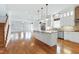 Open kitchen and living area with a large island, stainless appliances, and hardwood floors at 1509 Heritage Reserve Ct, Wake Forest, NC 27587