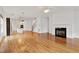 Bright living room featuring hardwood floors, fireplace, and open layout to the kitchen at 1509 Heritage Reserve Ct, Wake Forest, NC 27587
