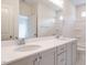 Bathroom with dual sinks, spacious vanity, large mirror and tub with tiled surround at 201 Wash Hollow Dr, Wendell, NC 27591