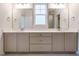 Elegant bathroom with dual vanities, quartz countertops, and a walk-in shower at 201 Wash Hollow Dr, Wendell, NC 27591
