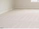 An empty bedroom featuring neutral carpet, a crisp white wall, and natural light at 201 Wash Hollow Dr, Wendell, NC 27591