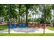 A view of a park with trees, a lawn and an arrangement of colorful Adirondack chairs at 201 Wash Hollow Dr, Wendell, NC 27591