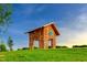 A view of a wood frame Community Structure atop a green hill with blue skies at 201 Wash Hollow Dr, Wendell, NC 27591