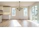 Bright dining area featuring hardwood floors, white walls, and an elegant light fixture at 201 Wash Hollow Dr, Wendell, NC 27591