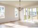 Bright dining room with hardwood floors, modern chandelier, and access to a screened porch at 201 Wash Hollow Dr, Wendell, NC 27591