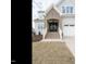 Charming home featuring a brick entryway, a two-car garage, and a newly installed lawn at 201 Wash Hollow Dr, Wendell, NC 27591
