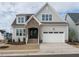 Charming home featuring a brick entryway, a two-car garage, and a well-manicured front yard at 201 Wash Hollow Dr, Wendell, NC 27591