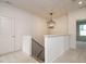 Upstairs landing featuring a modern pendant light and an open view to other rooms at 201 Wash Hollow Dr, Wendell, NC 27591