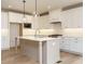 Modern kitchen with white cabinets, stainless appliances, and a large center island at 201 Wash Hollow Dr, Wendell, NC 27591