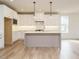 Spacious kitchen featuring white cabinetry, hardwood floors, and a center island at 201 Wash Hollow Dr, Wendell, NC 27591