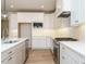 Well-lit modern kitchen with white cabinets, stainless steel appliances, and a large island at 201 Wash Hollow Dr, Wendell, NC 27591