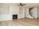 Spacious living room featuring a fireplace with custom built-ins, a ceiling fan, and hardwood floors at 201 Wash Hollow Dr, Wendell, NC 27591