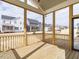 Screened porch with view of other homes and landscaping at 201 Wash Hollow Dr, Wendell, NC 27591